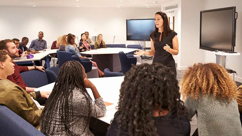 Instructor addresses students in a classroom