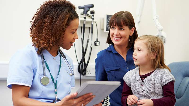 Medical provider speaking with mother and child