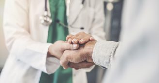 Health worker holding patient’s hand